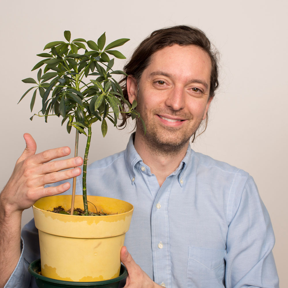 Andrew holding a plant