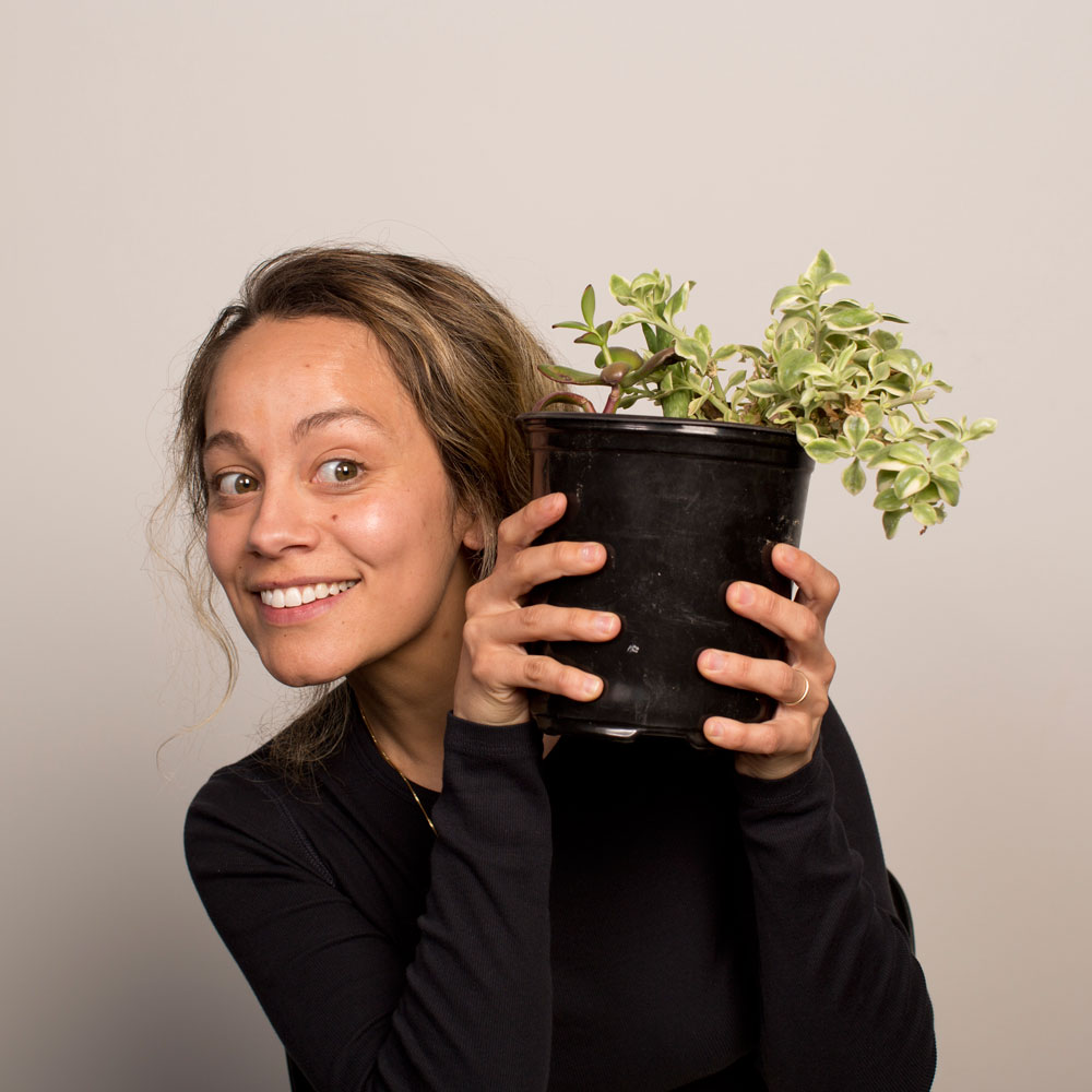 Jeannine holding a plant